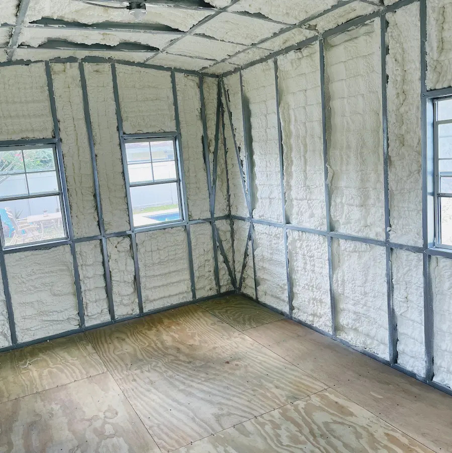 Closed-cell spray foam insulation applied to wall cavities in a residential project in Kensington